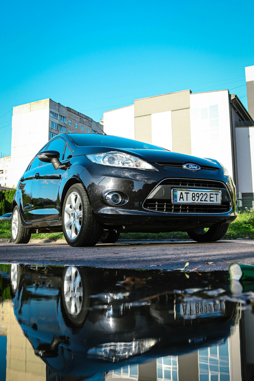 a black car parked in front of a building