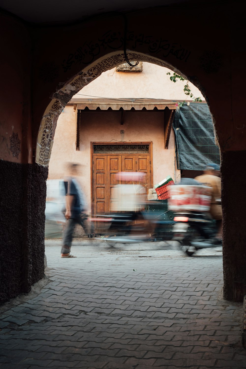 a man riding a bike down a street next to a building