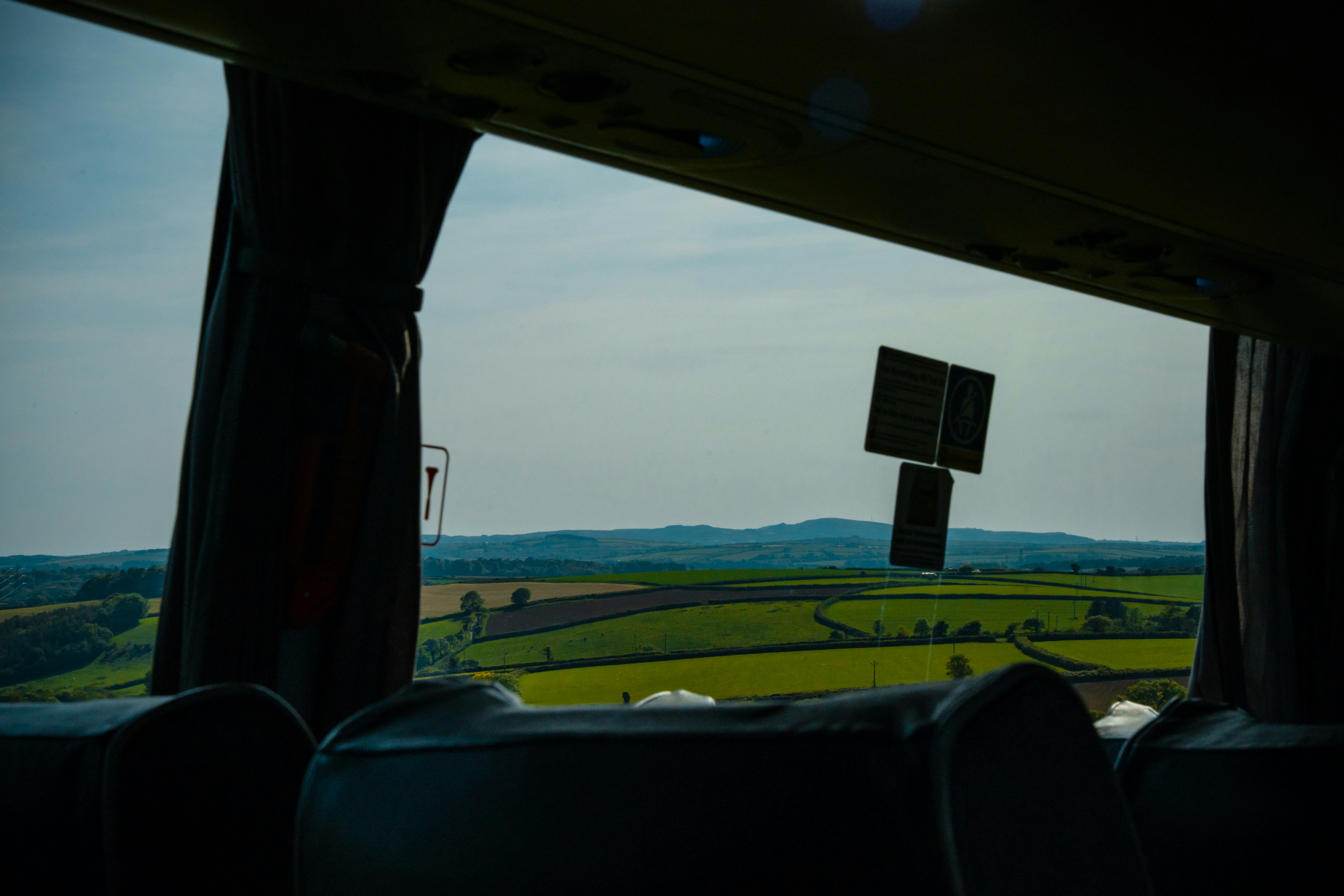 a view of a field from inside a vehicle