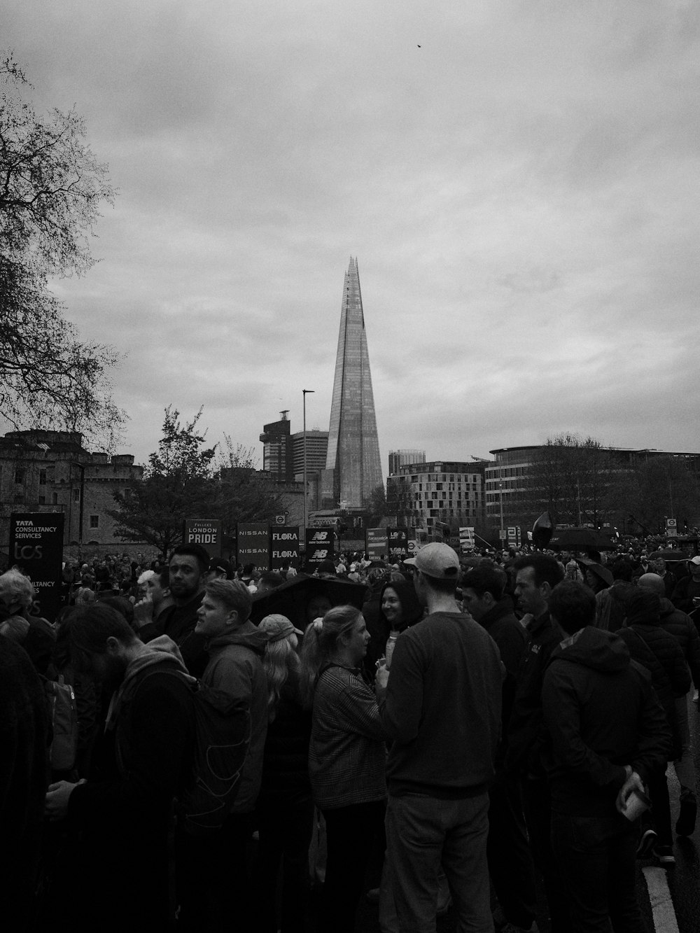 a large group of people standing in front of a tall building