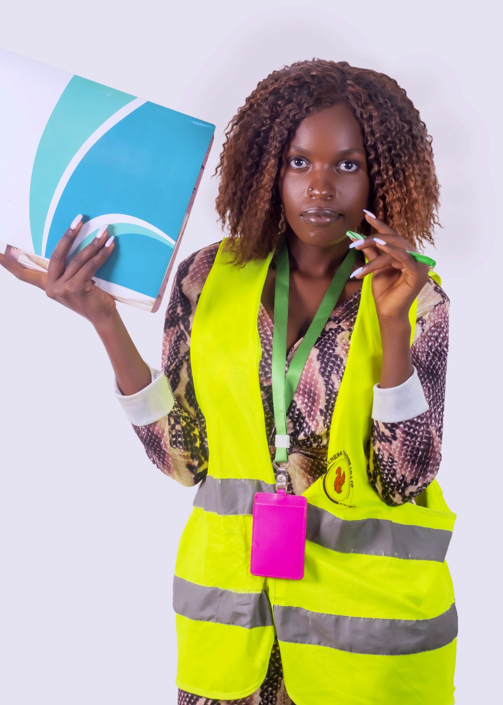 a woman in a safety vest holding a laptop