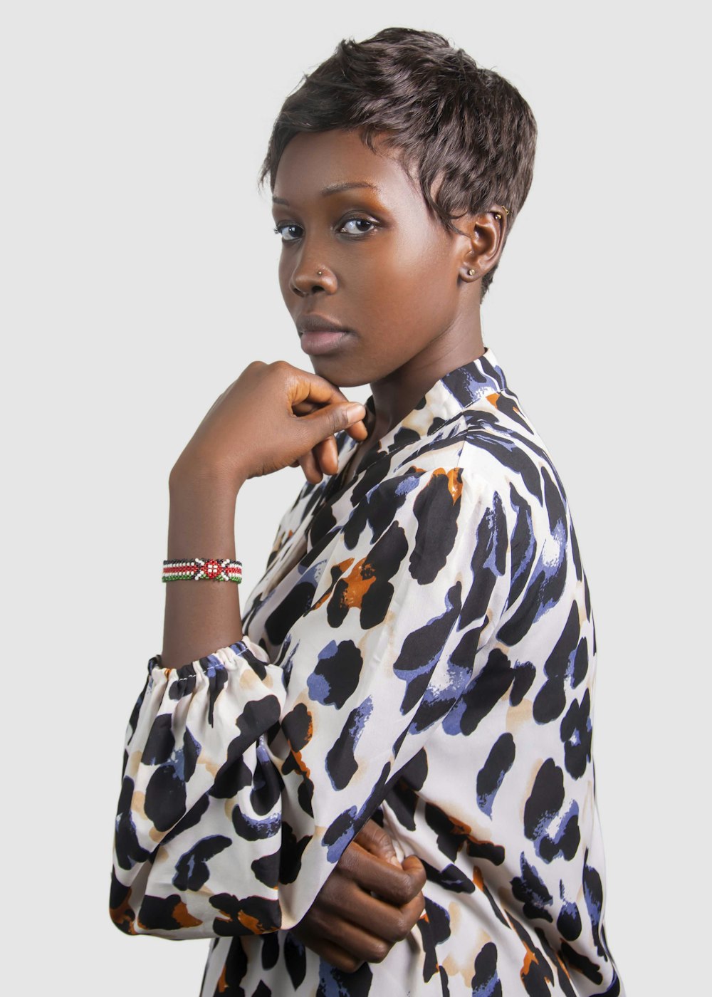 a woman wearing a black and white shirt and a bracelet