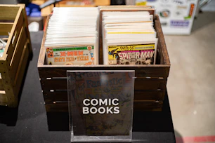 a wooden box with comic books inside of it