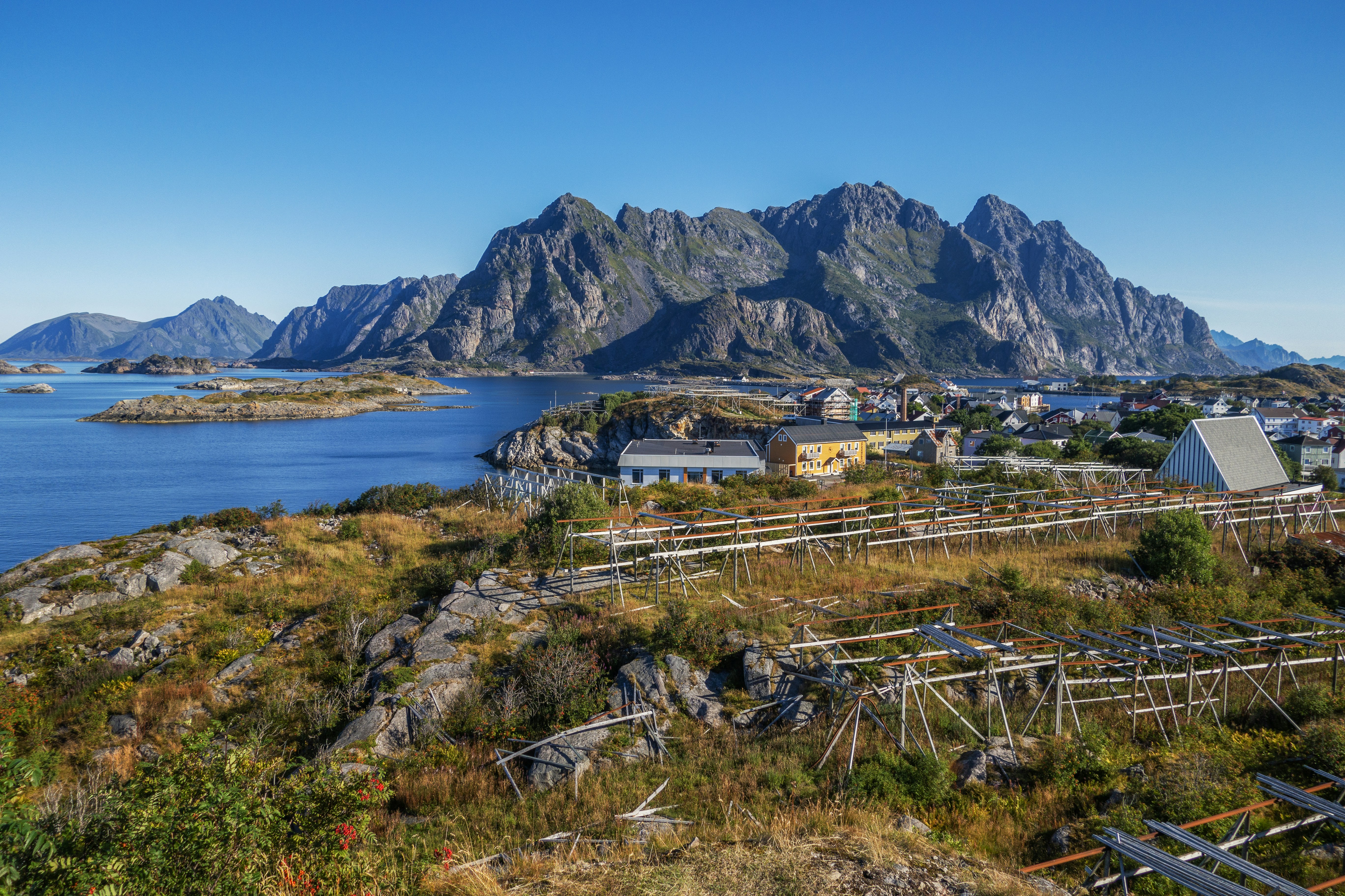 a scenic view of a small town with mountains in the background