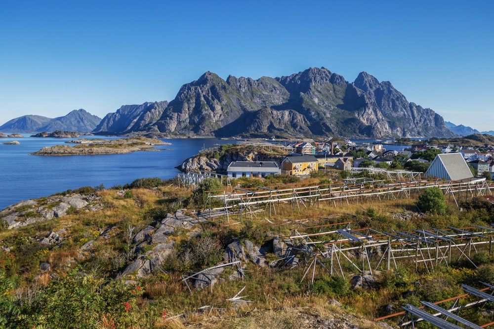 a scenic view of a small town with mountains in the background