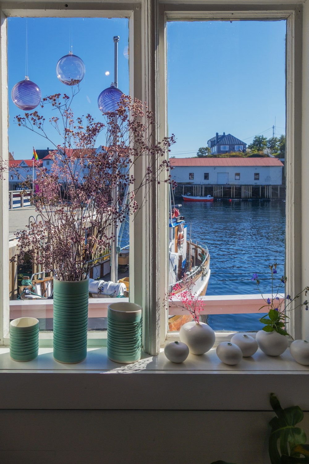 a couple of vases sitting on top of a window sill