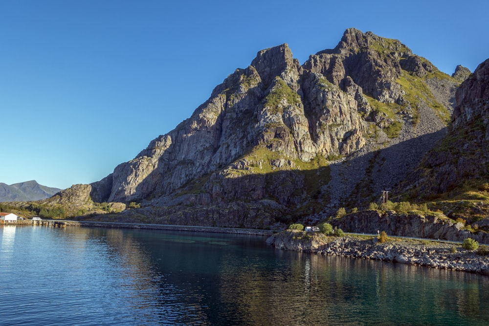 a body of water with mountains in the background