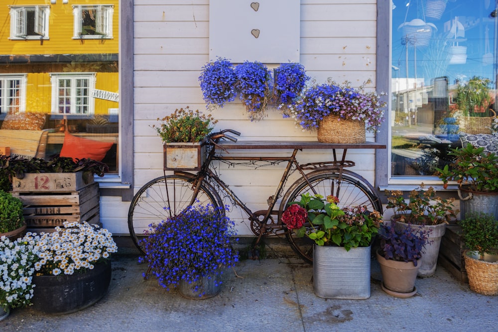 a bicycle is parked outside of a flower shop