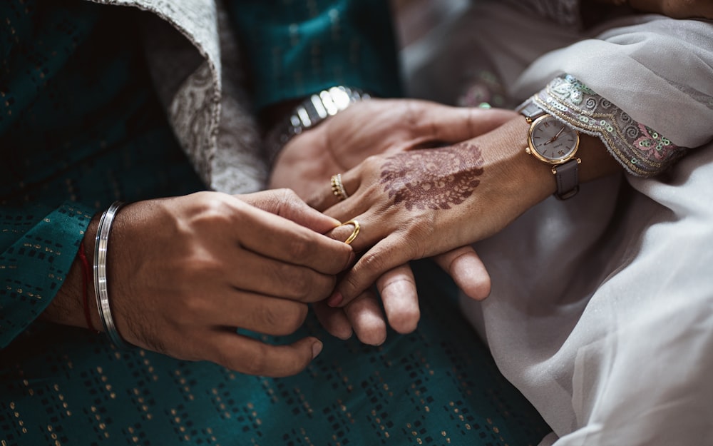 a close up of a person holding another person's hand