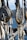 Close-up view of ship rigging involving weathered ropes and pulleys with a background of blurred water and distant scenery.