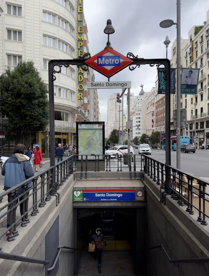 A vibrant street scene in Santo Domingo with locals reading newspapers and using smartphones.