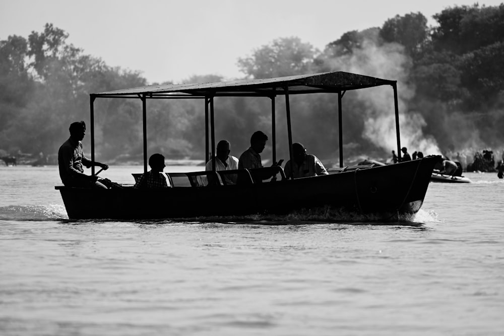 a black and white photo of people in a boat