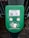 A green electronic device for ticket activation with instructions in Russian. It features a QR code, NFC symbol, and an illustration indicating where to place a card. The background consists of a pavement area partially visible.