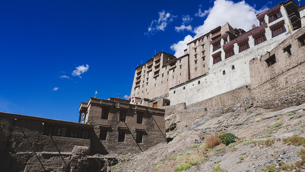 a very tall building sitting on the side of a hill