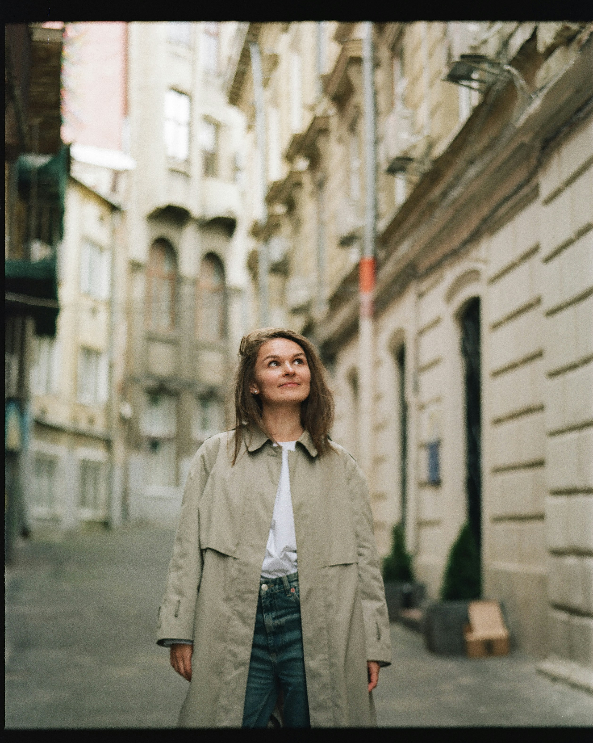 a woman standing in the middle of a street