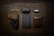 A neatly organized firearm accessory kit laid out on a wooden table.
