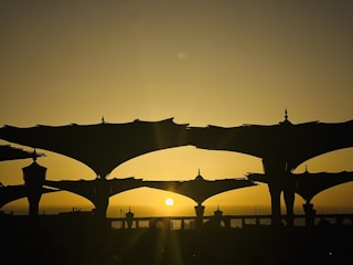 A dramatic Sicilian landscape at sunset with traditional festival decorations.