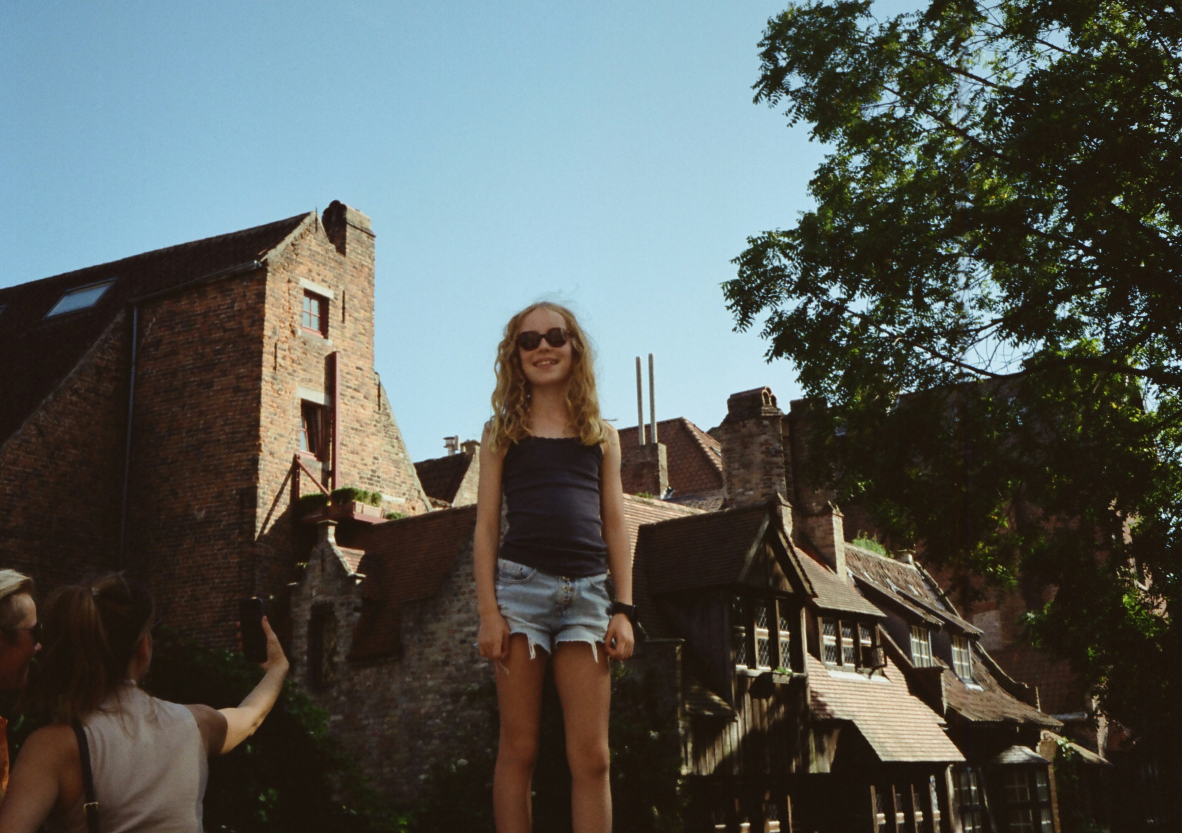 a woman standing on top of a skateboard in front of a building