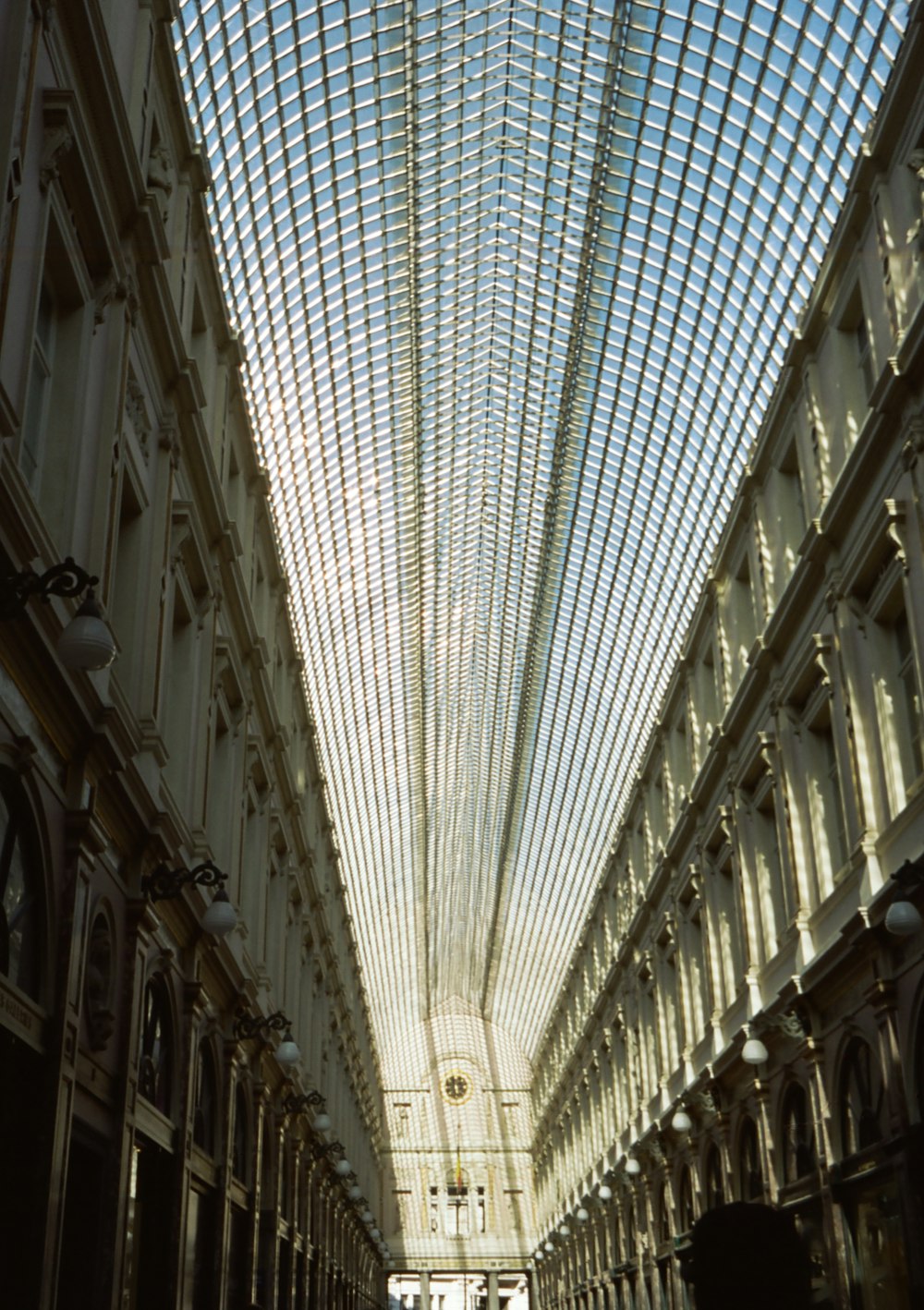 a large building with a glass ceiling and a clock on the wall