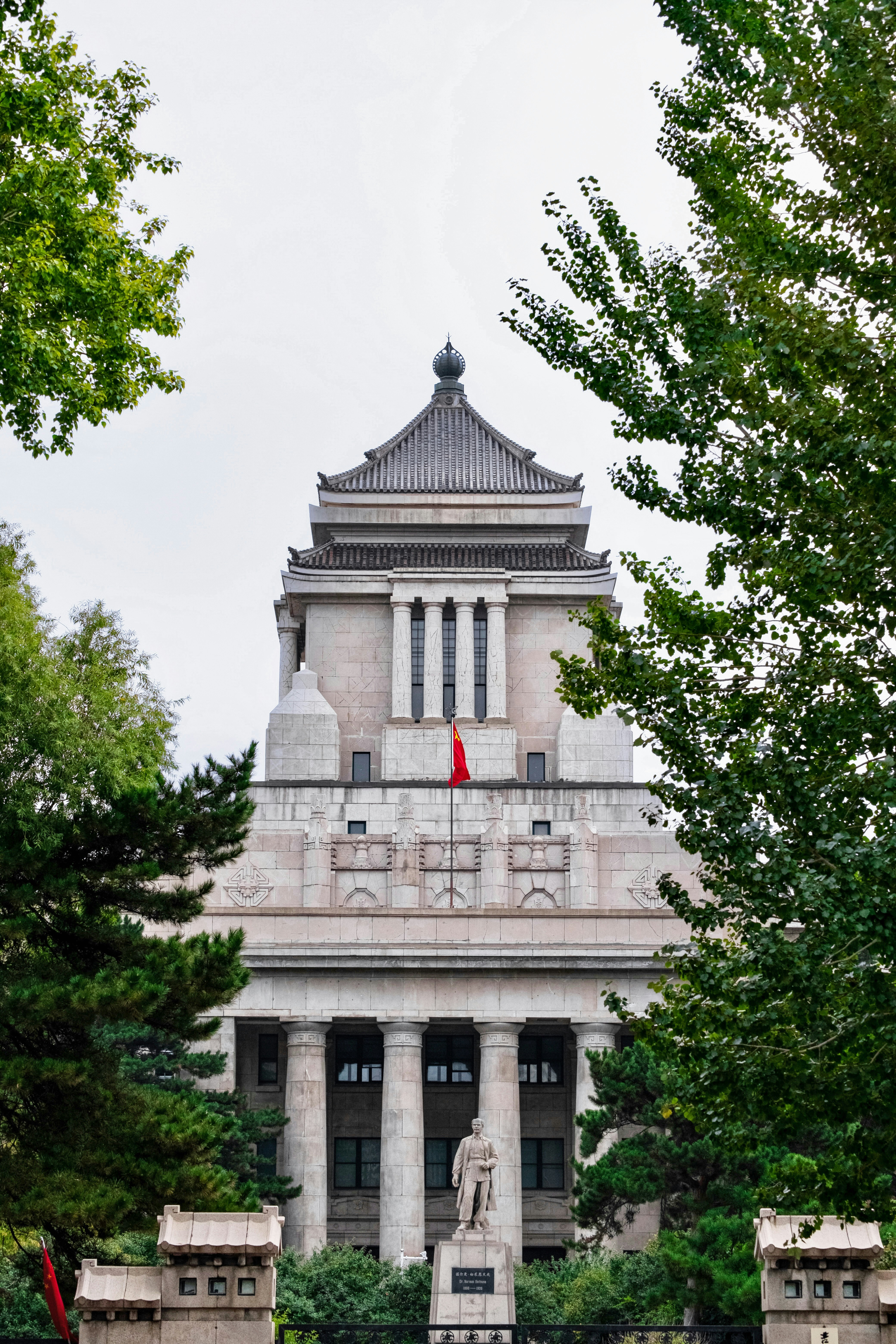 A large building with a statue in front of it photo – Free City Image ...