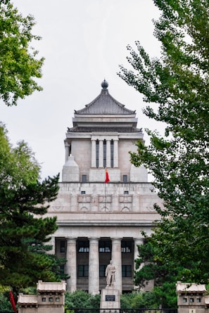 a large building with a statue in front of it