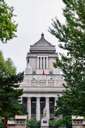 a large building with a statue in front of it