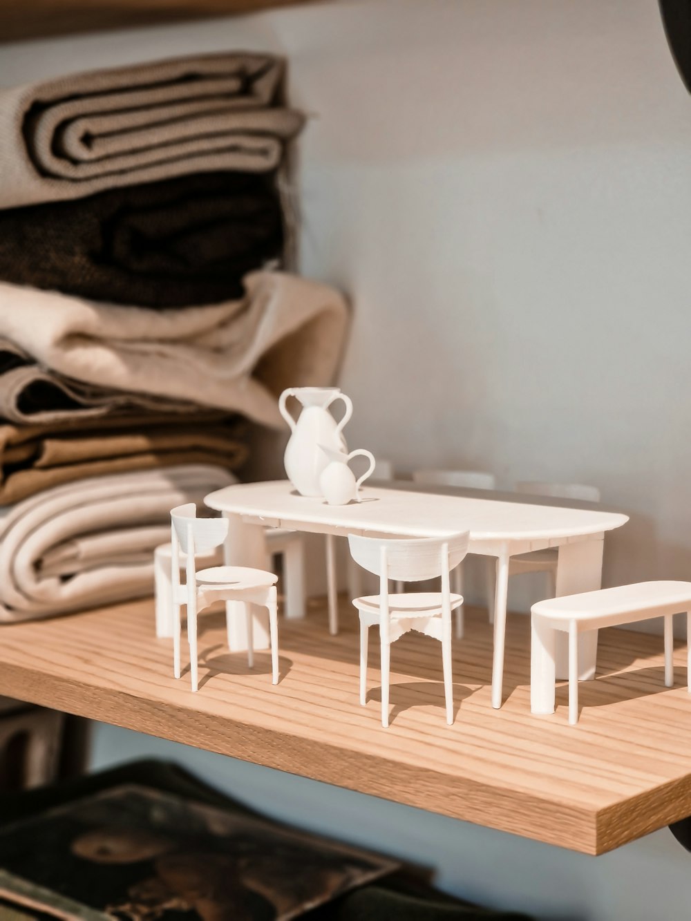 a model of a table and chairs on a shelf