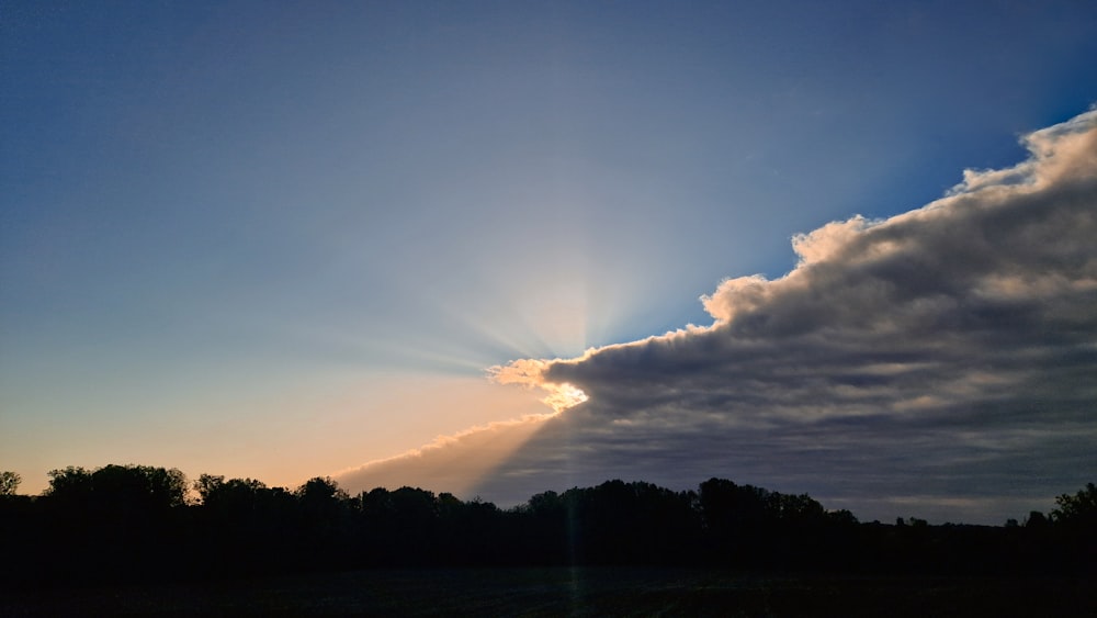 the sun is shining through the clouds in the sky