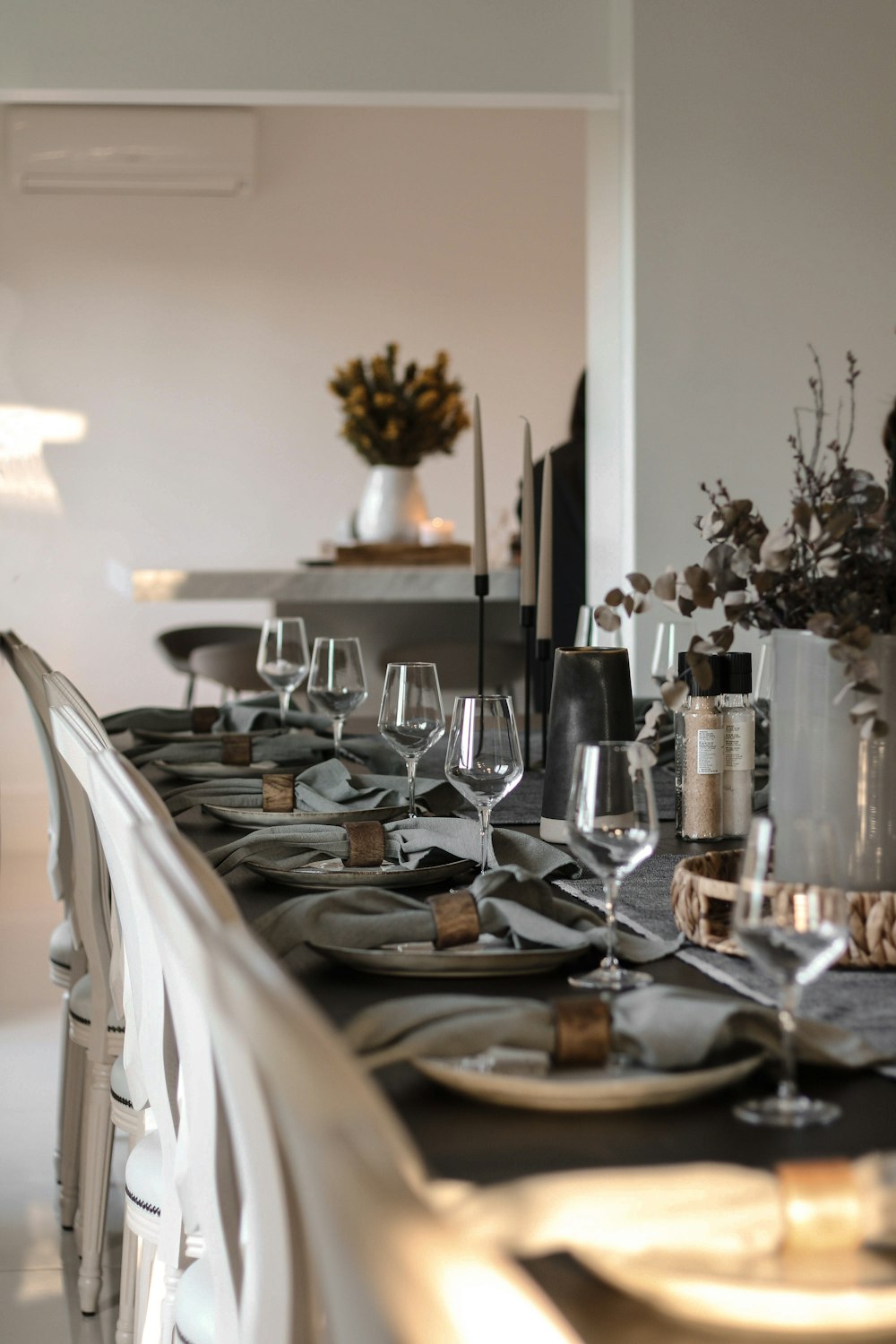 a long table is set with wine glasses and place settings