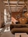Photo of a cozy living room renovated with warm earth tones and wooden accents.