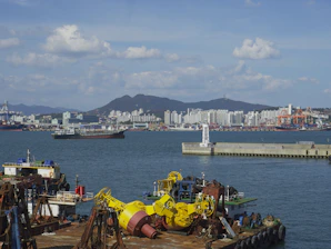 A vibrant harbor scene showing ships docked and service providers interacting with ship captains under a clear sky.