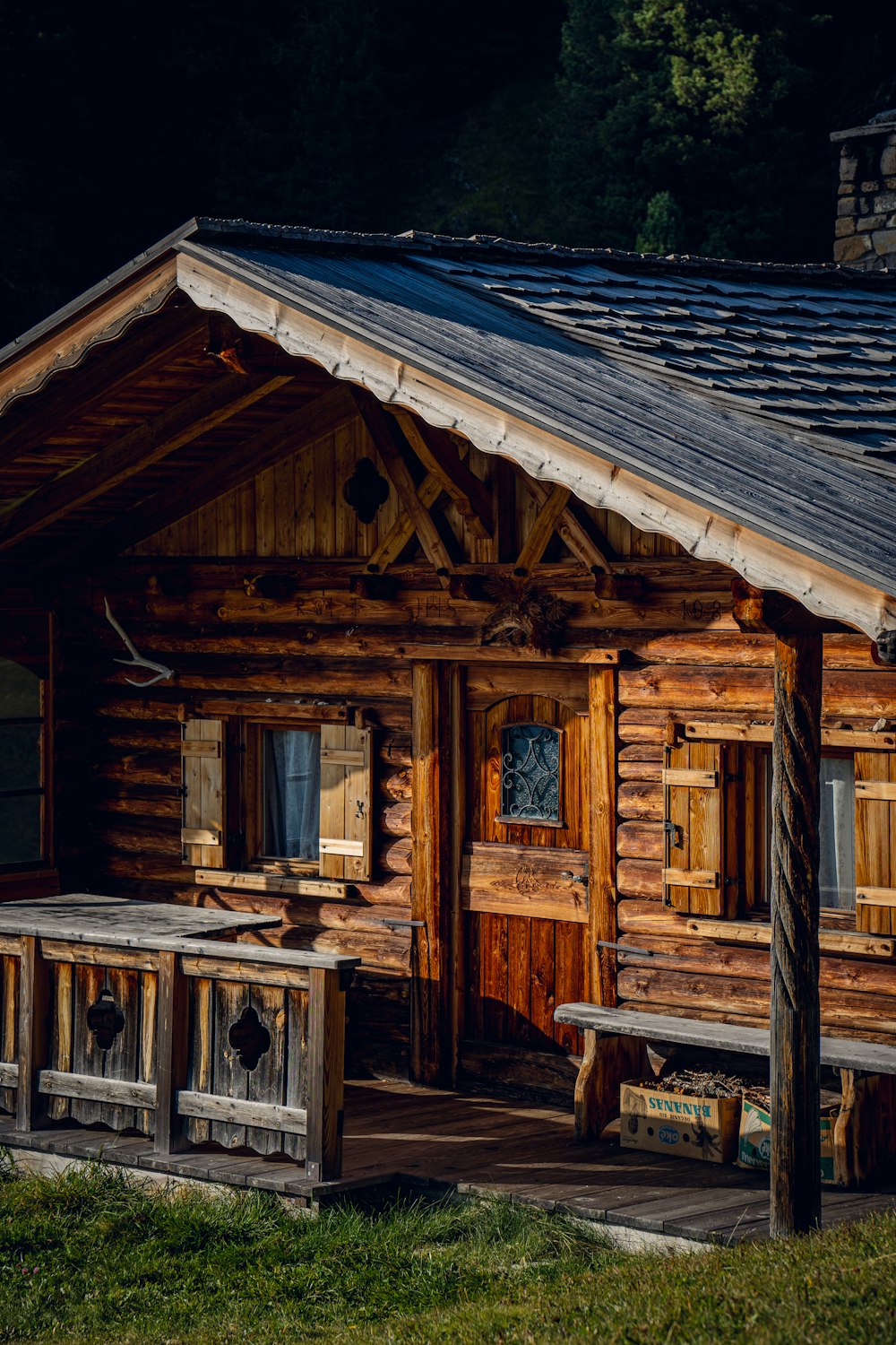 a log cabin with a picnic table in front of it