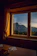 Cozy wooden breakfast nook with sunlight streaming through alpine windows.