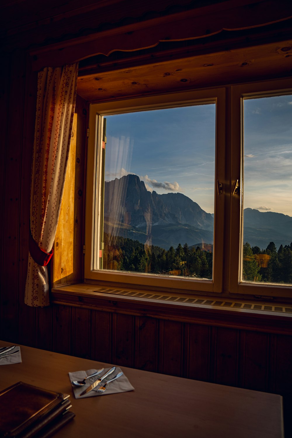 a window with a view of the mountains outside