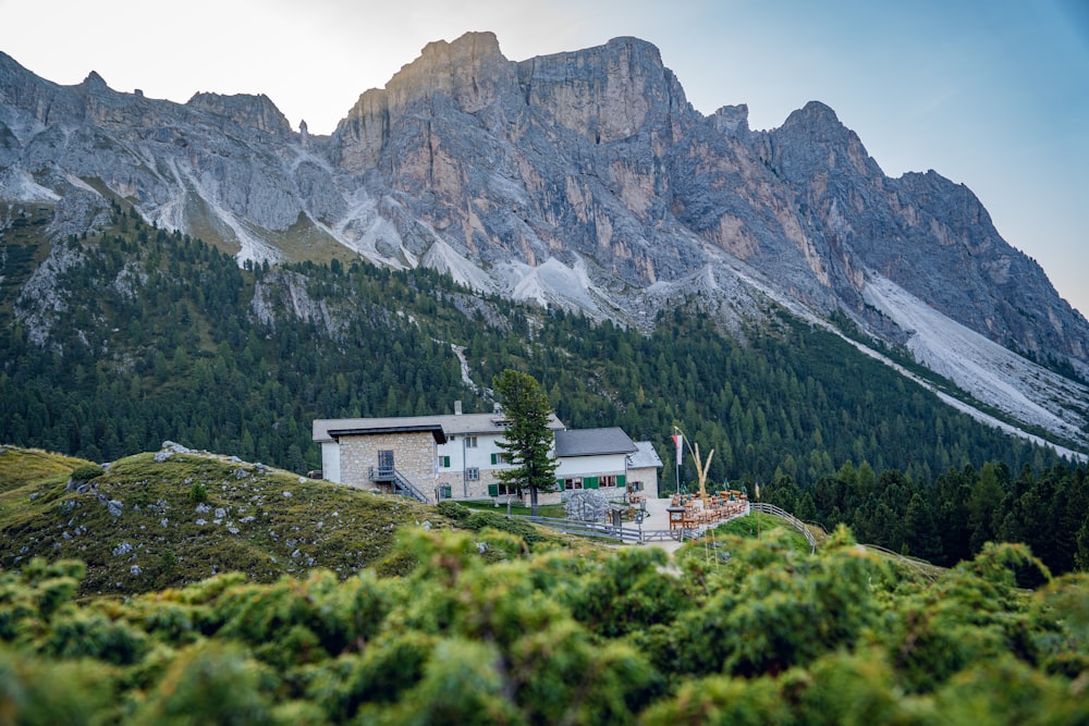 a house in the middle of a mountain range