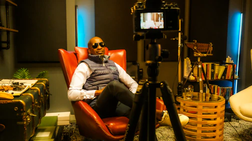 Portrait of a storyteller filming a documentary interview in a cozy indoor setting.