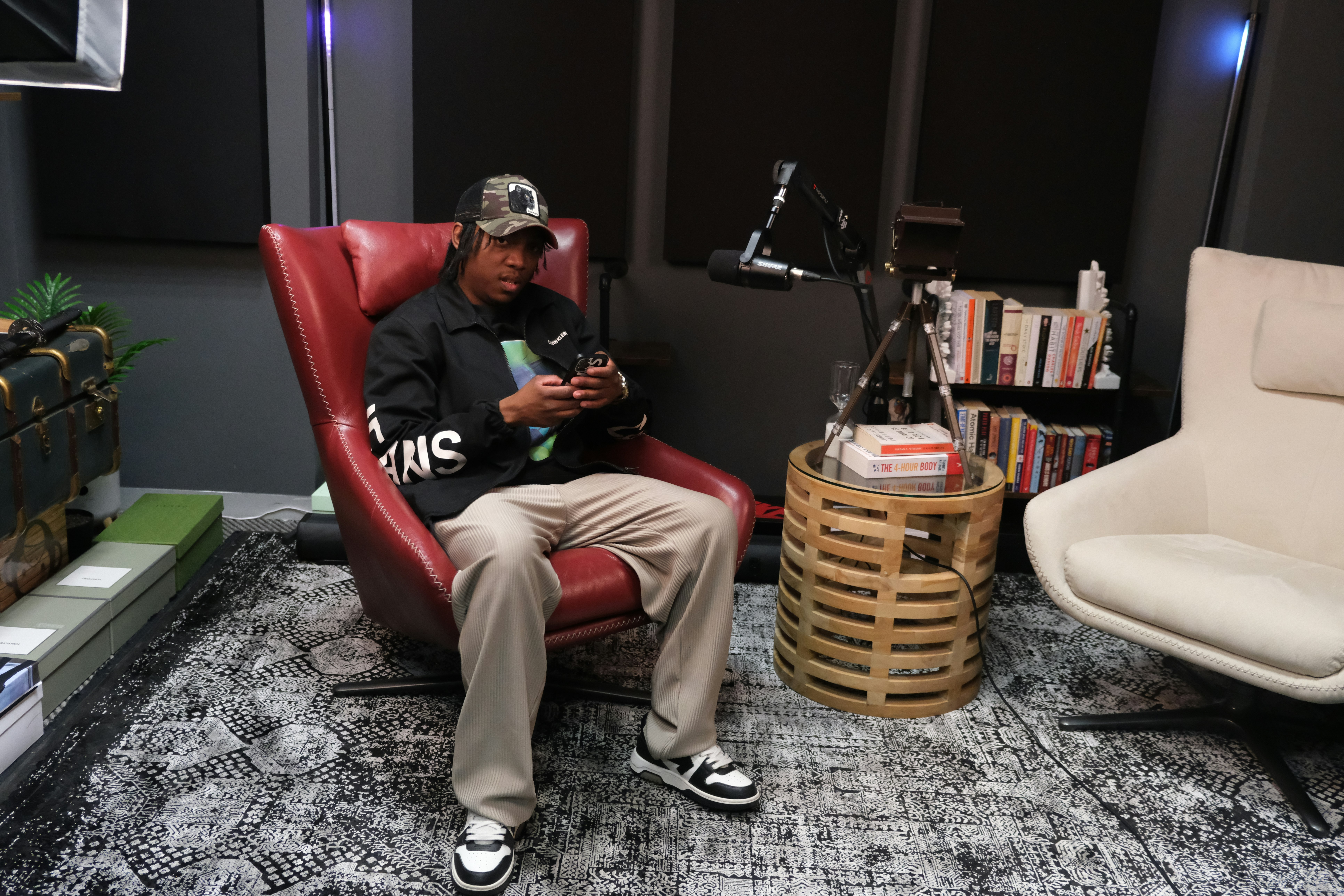a man sitting in a red chair in a room