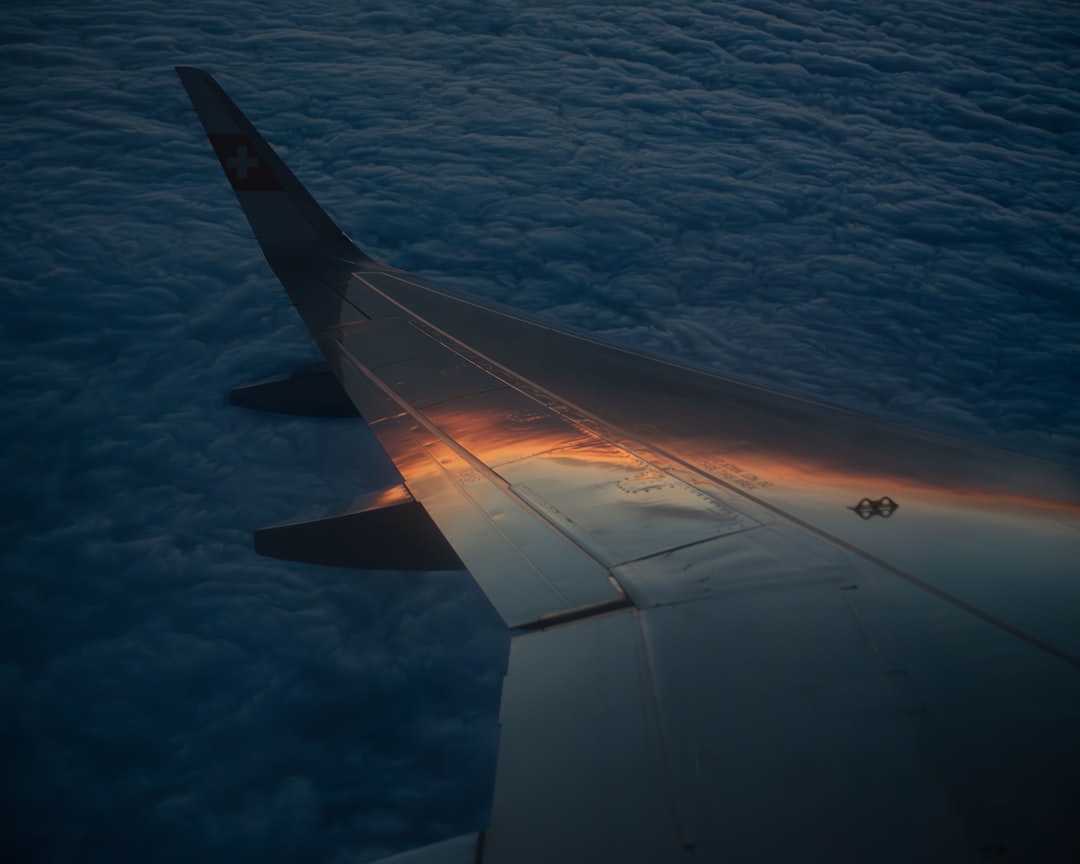 the wing of an airplane flying above the clouds,