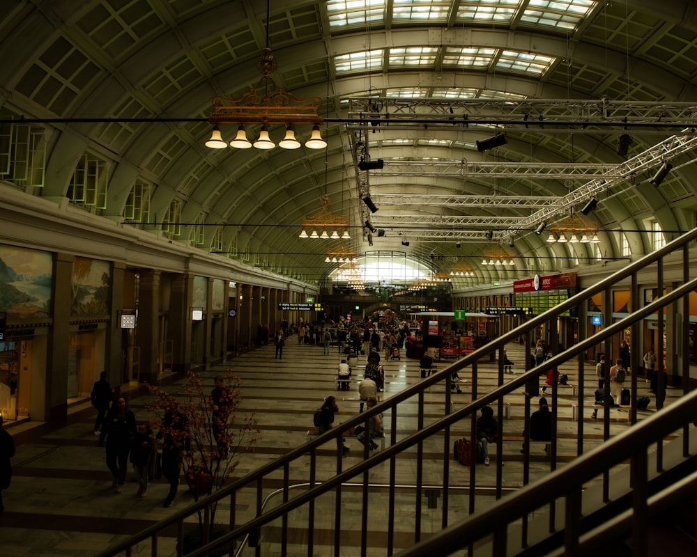 a group of people walking through a train station