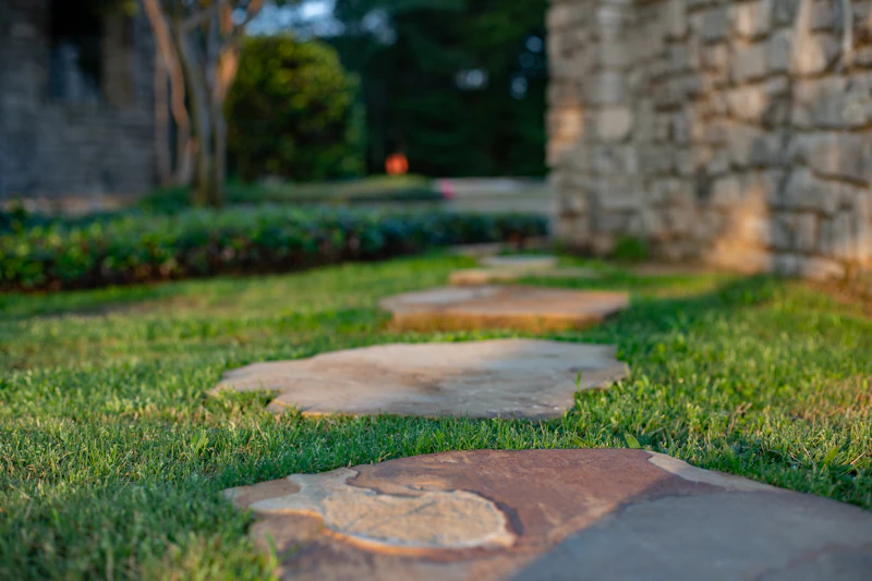 Stone walkway through a landscaped yard