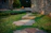 Close-up of a beautifully installed stone paver pathway winding through a lush garden.