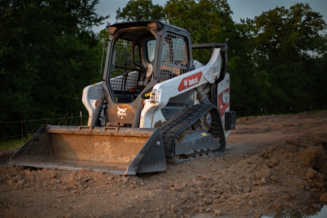 Photo of a Bobcat T590 compact loader clearing a construction site.