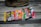 A collection of vintage baseball card packs, arranged in a row, displayed on a wooden surface with a baseball glove partially visible in the background.
