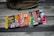A collection of vintage baseball card packs, arranged in a row, displayed on a wooden surface with a baseball glove partially visible in the background.