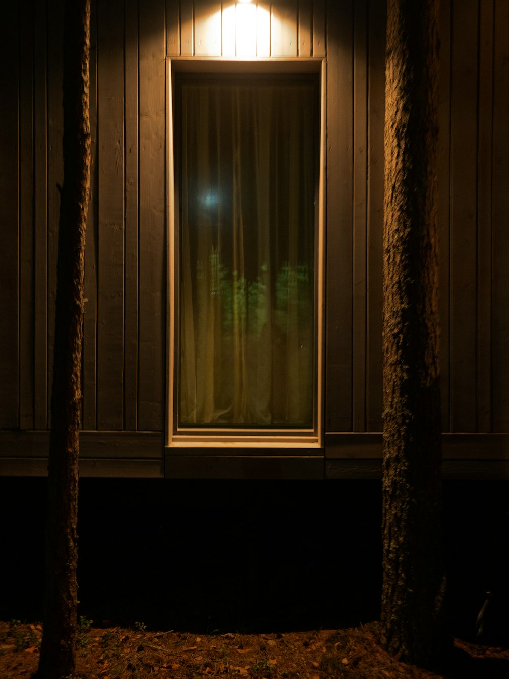 a window in a house with a light on