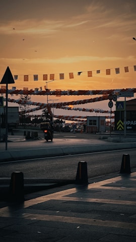 A double-sided flag banner trailing behind a glowing bike under city lights.