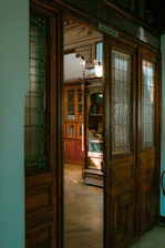 A serene doorway opening to a softly lit room filled with books and calm shadows.