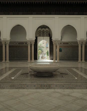 Historic riad courtyard showcasing traditional Moroccan arches and mosaic tiles.