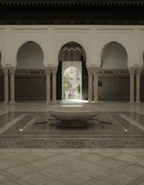 An elegant courtyard inside the Marrakech riad showcasing traditional tilework and lush greenery.