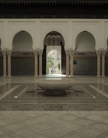 A luxurious private riad courtyard with intricate tilework and lush greenery.